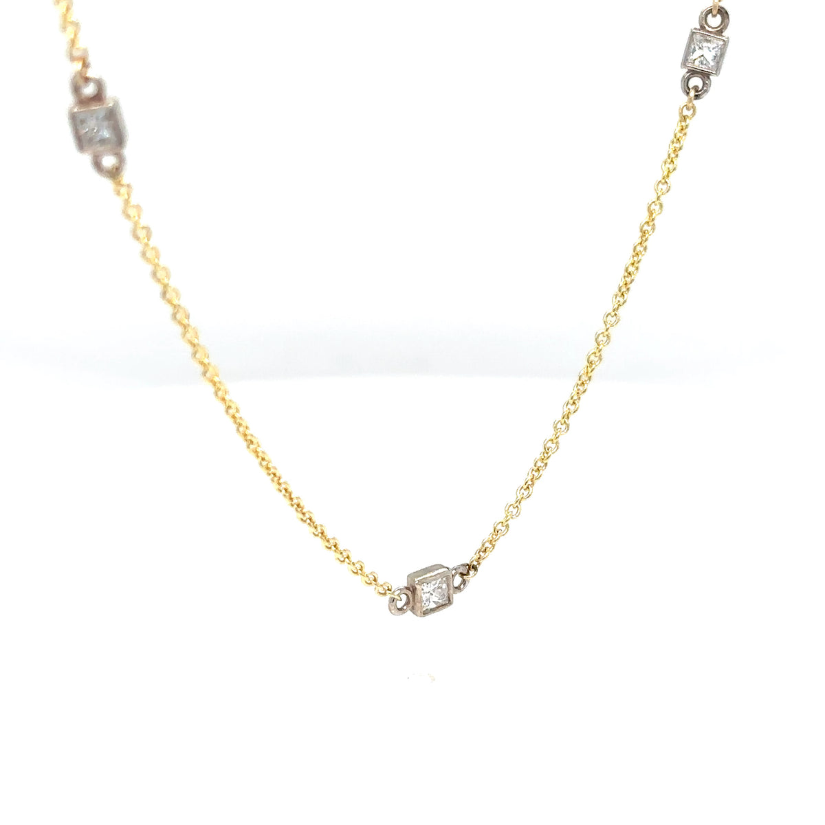 Gold necklace with diamond accents on a white background