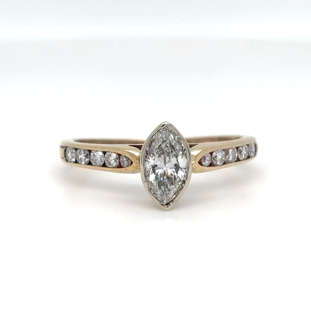 Diamond ring with a pear-shaped center stone on a white background