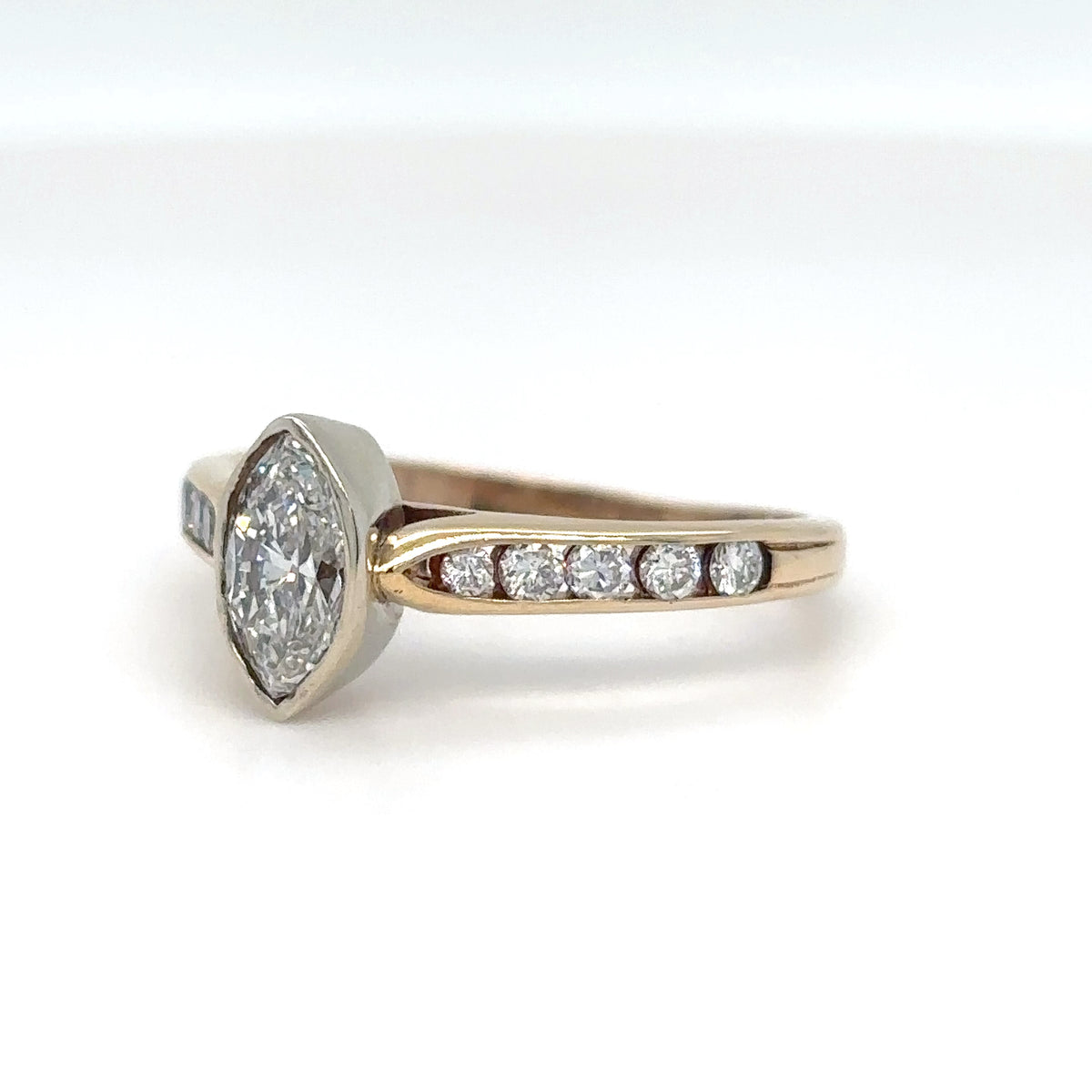 Diamond ring with a hexagonal center stone on a white background