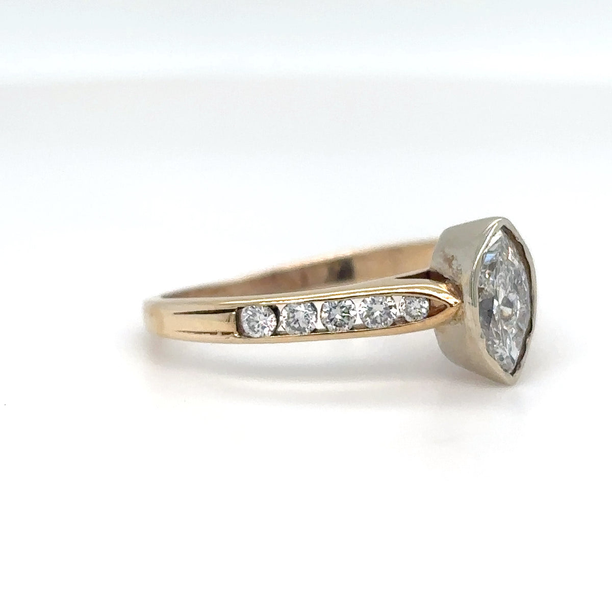 Gold ring with a diamond on a white background