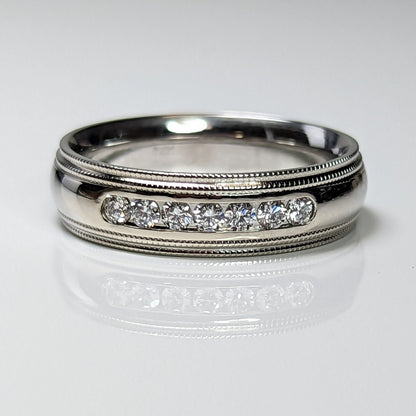 Silver ring with diamond accents on a white background