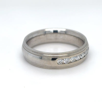 Silver ring with diamond accents on a white background