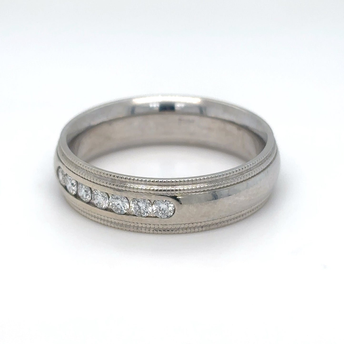 Silver ring with embedded diamonds on a white background