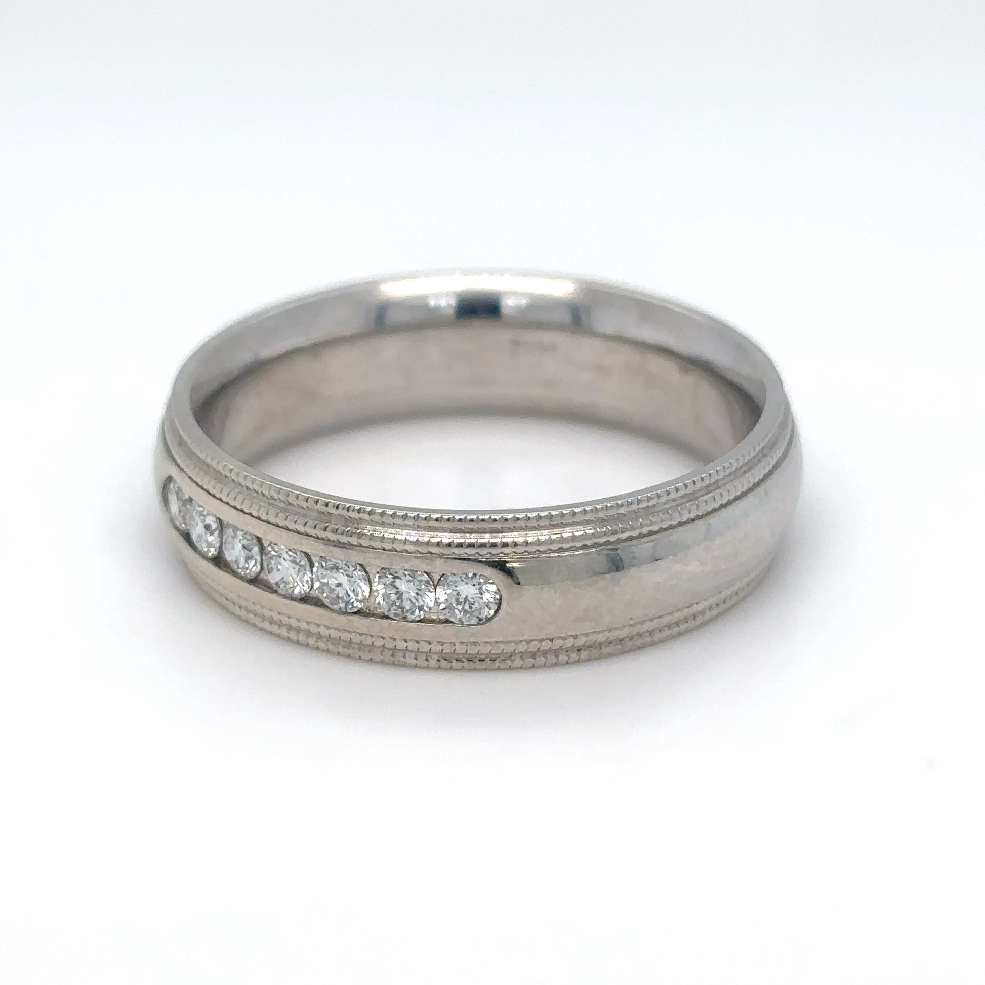 Silver ring with embedded diamonds on a white background