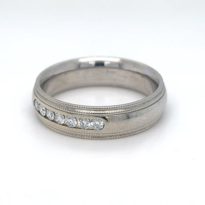 Silver ring with embedded diamonds on a white background
