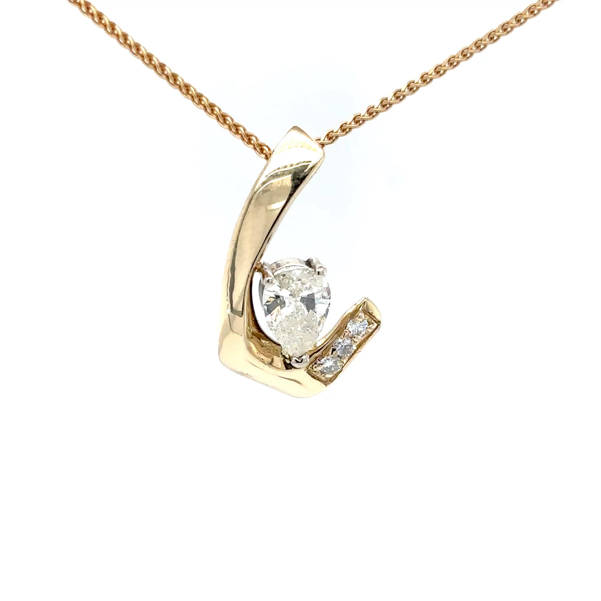Gold necklace with a pear-shaped diamond pendant on a white background