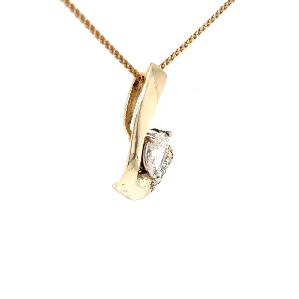 Gold pendant with a diamond on a white background