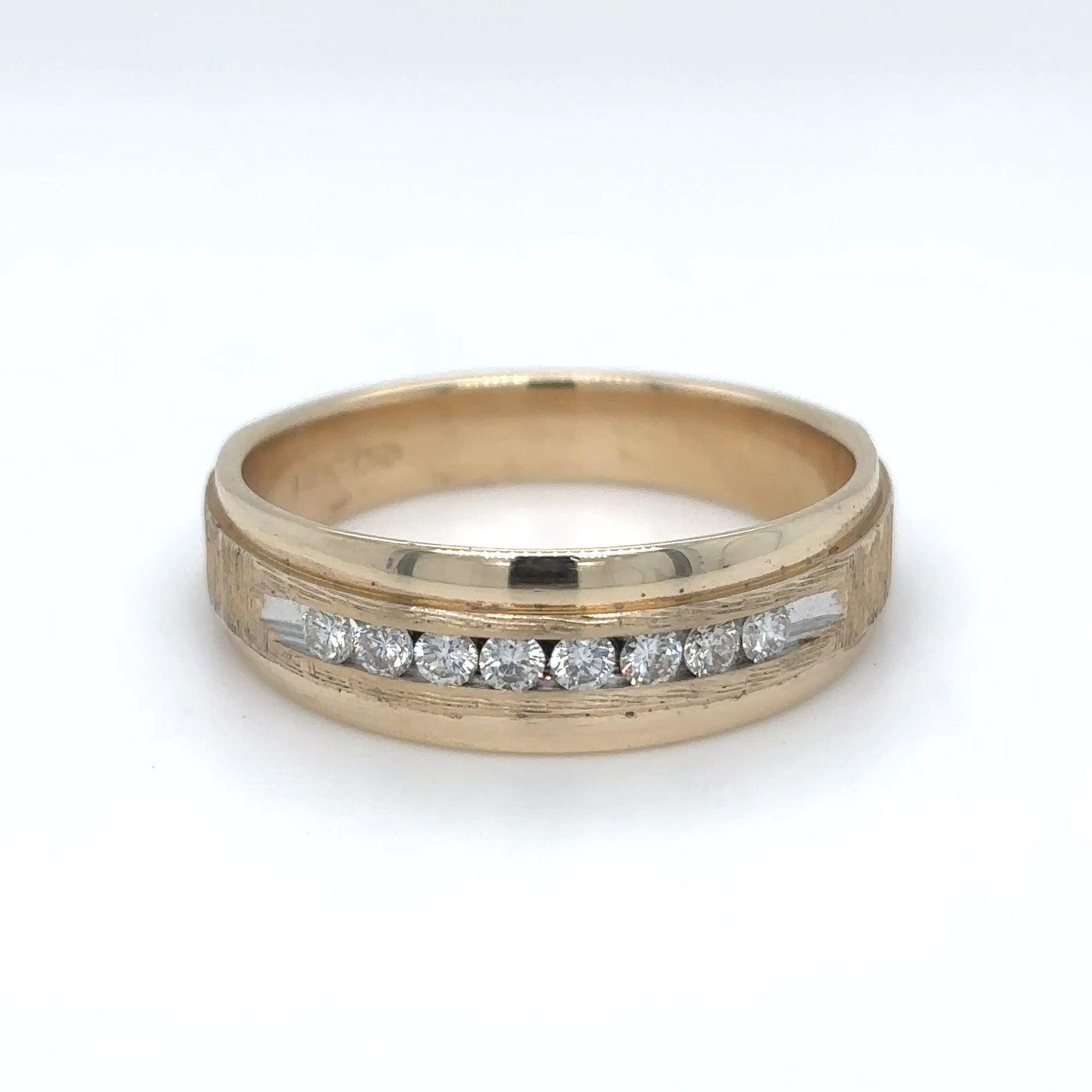 Gold ring with embedded diamonds on a white background