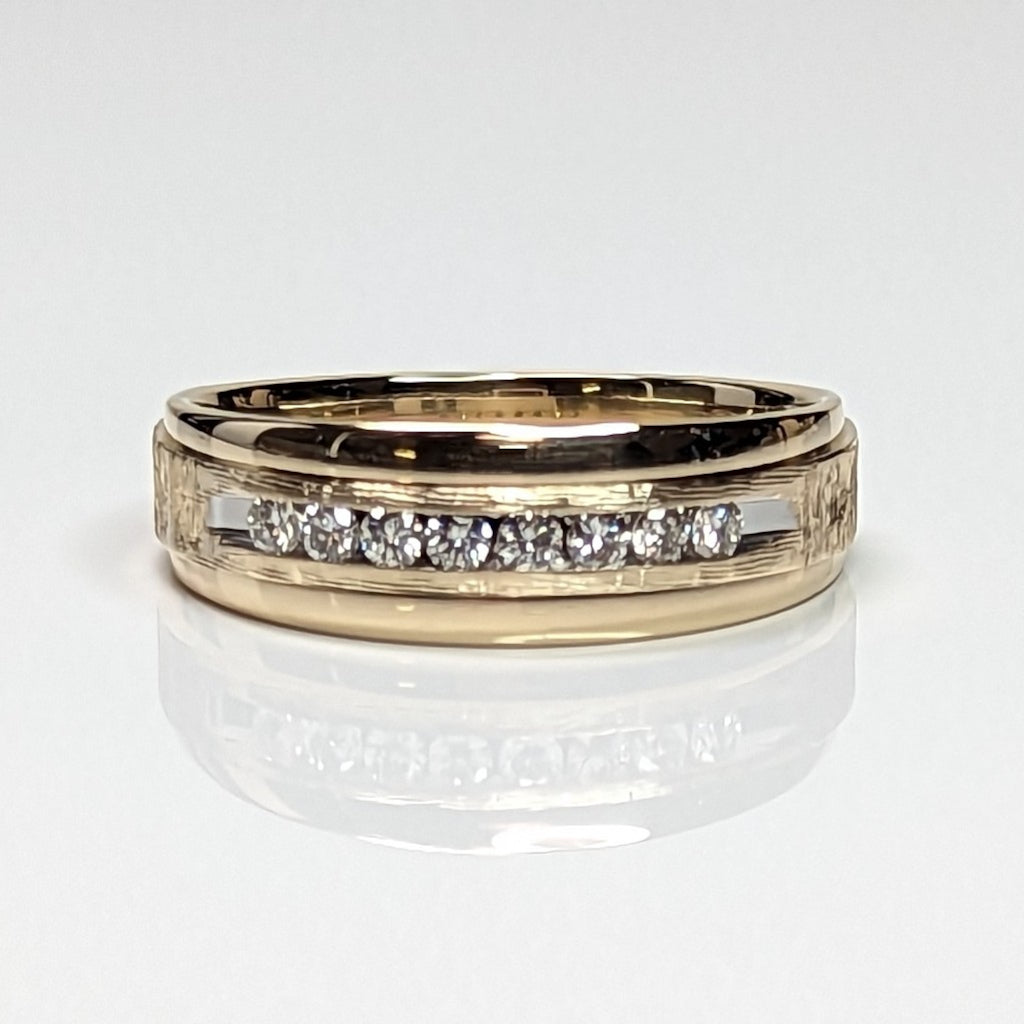 Gold ring with embedded diamonds on a white background