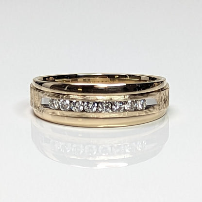 Gold ring with embedded diamonds on a white background