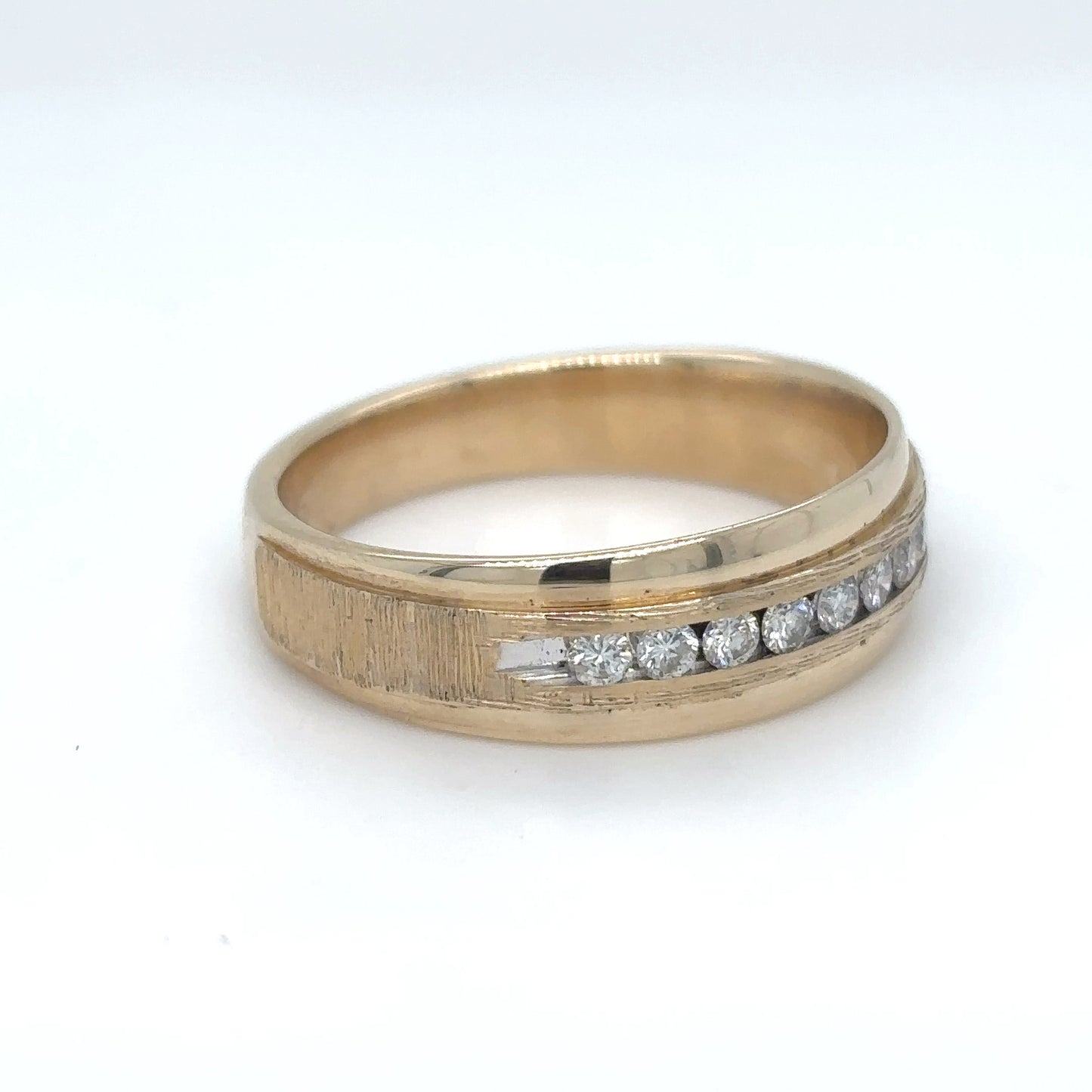 Gold ring with diamonds on a white background