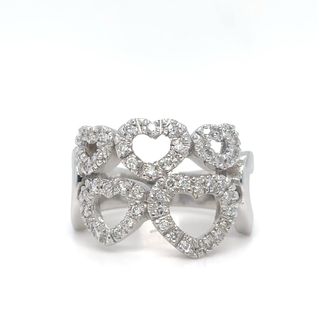 Silver ring with heart designs on a white background