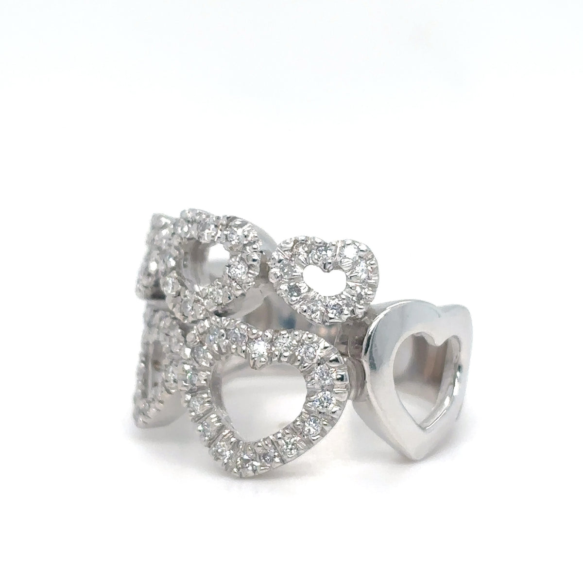 Silver heart-shaped earrings with clear gemstones on a white background