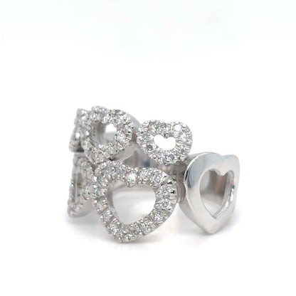Silver heart-shaped earrings with clear gemstones on a white background