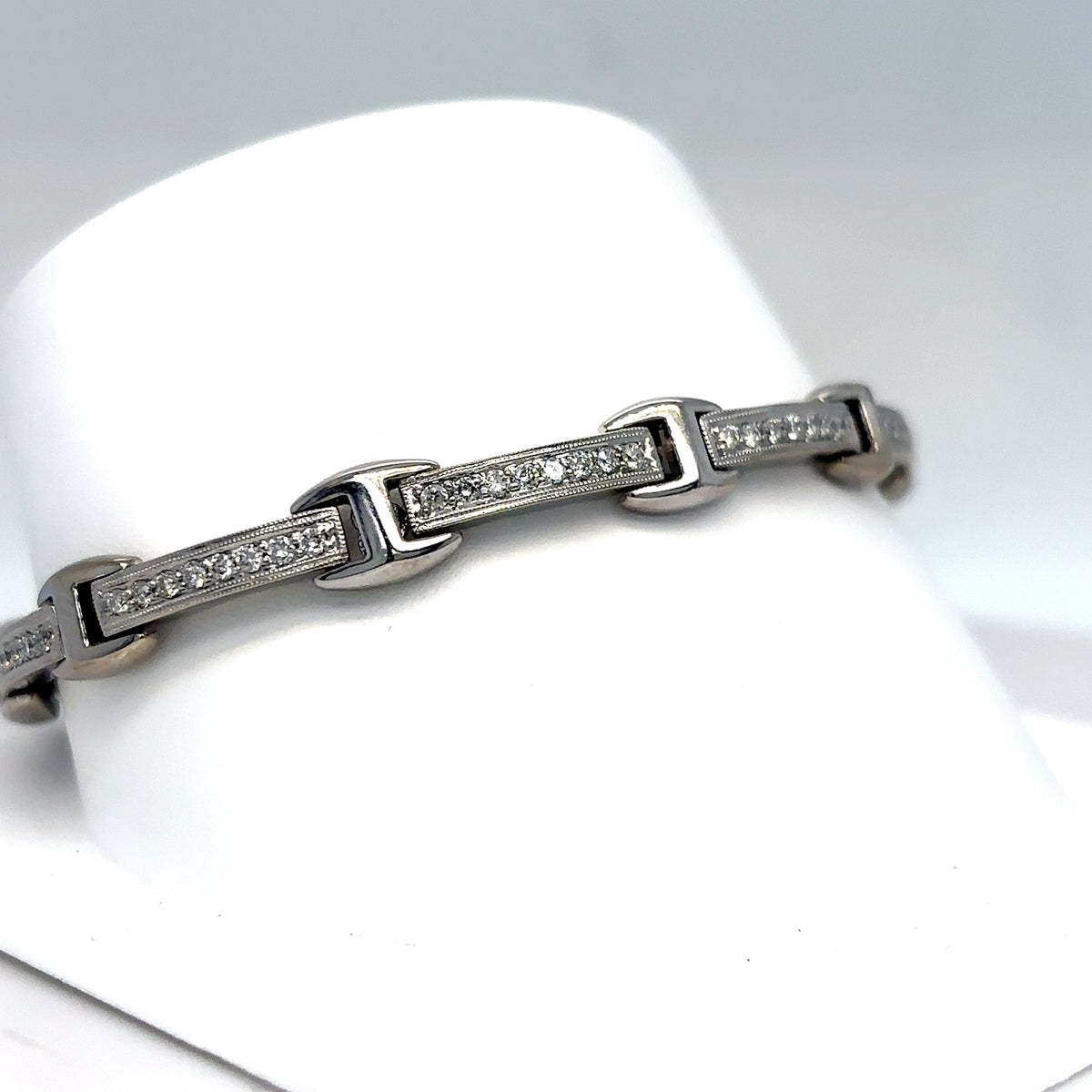 Silver bracelet with diamond accents on a white mannequin hand