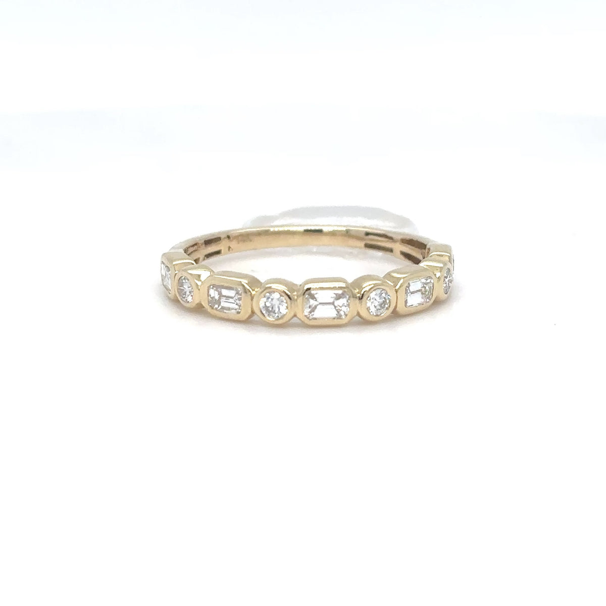 A 14K yellow gold ring featuring a row of alternating emerald-cut and round brilliant diamonds, shown on a plain white background.