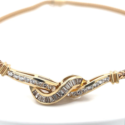 Gold bracelet with diamond accents on a white background