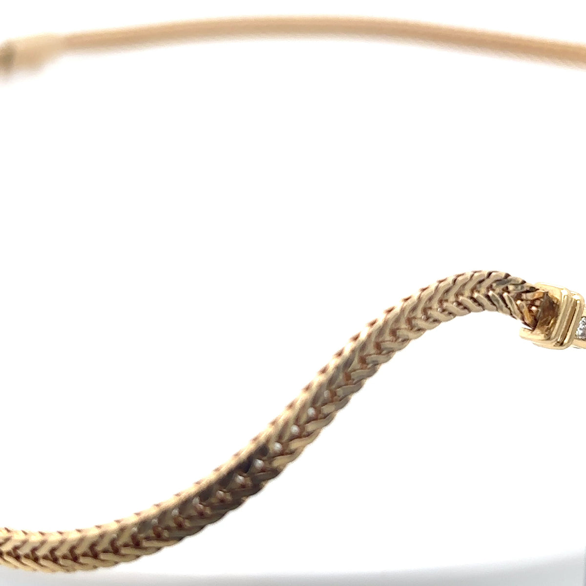 Gold bracelet on a white background
