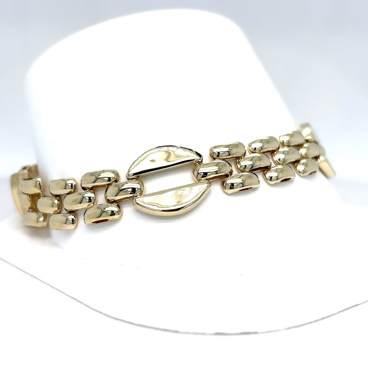 Gold bracelet on a white mannequin hand