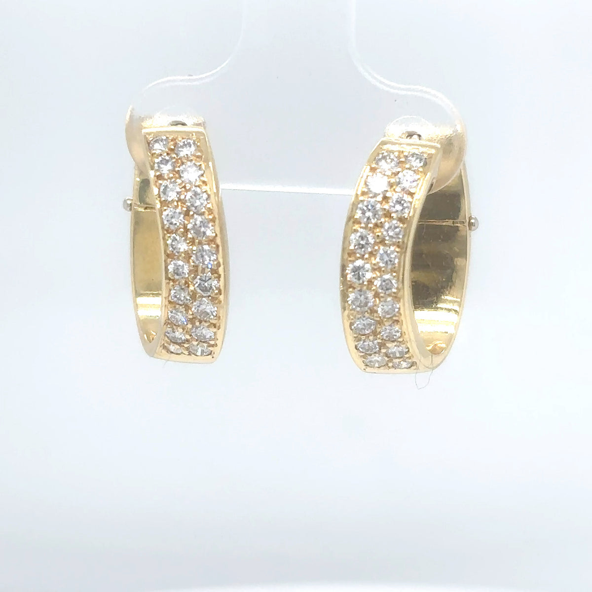 Gold hoop earrings with diamond accents on a white background