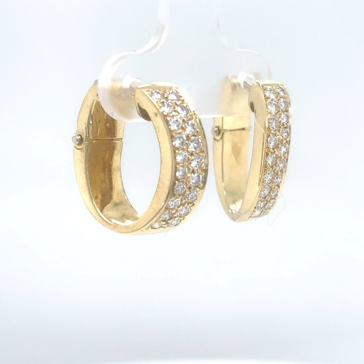 Gold hoop earrings with embedded stones on a white background