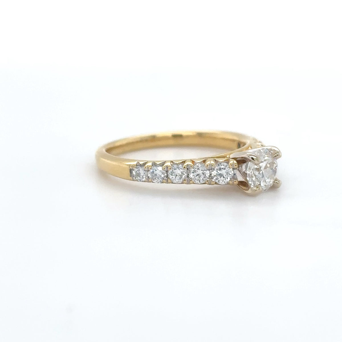 Gold ring with diamonds on a white background