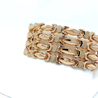 Gold chain bracelet on a white background
