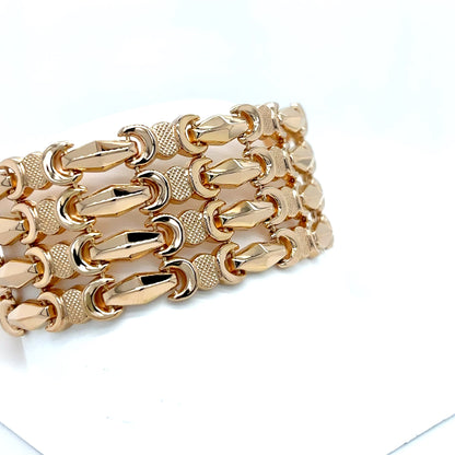 Gold chain bracelet on a white background