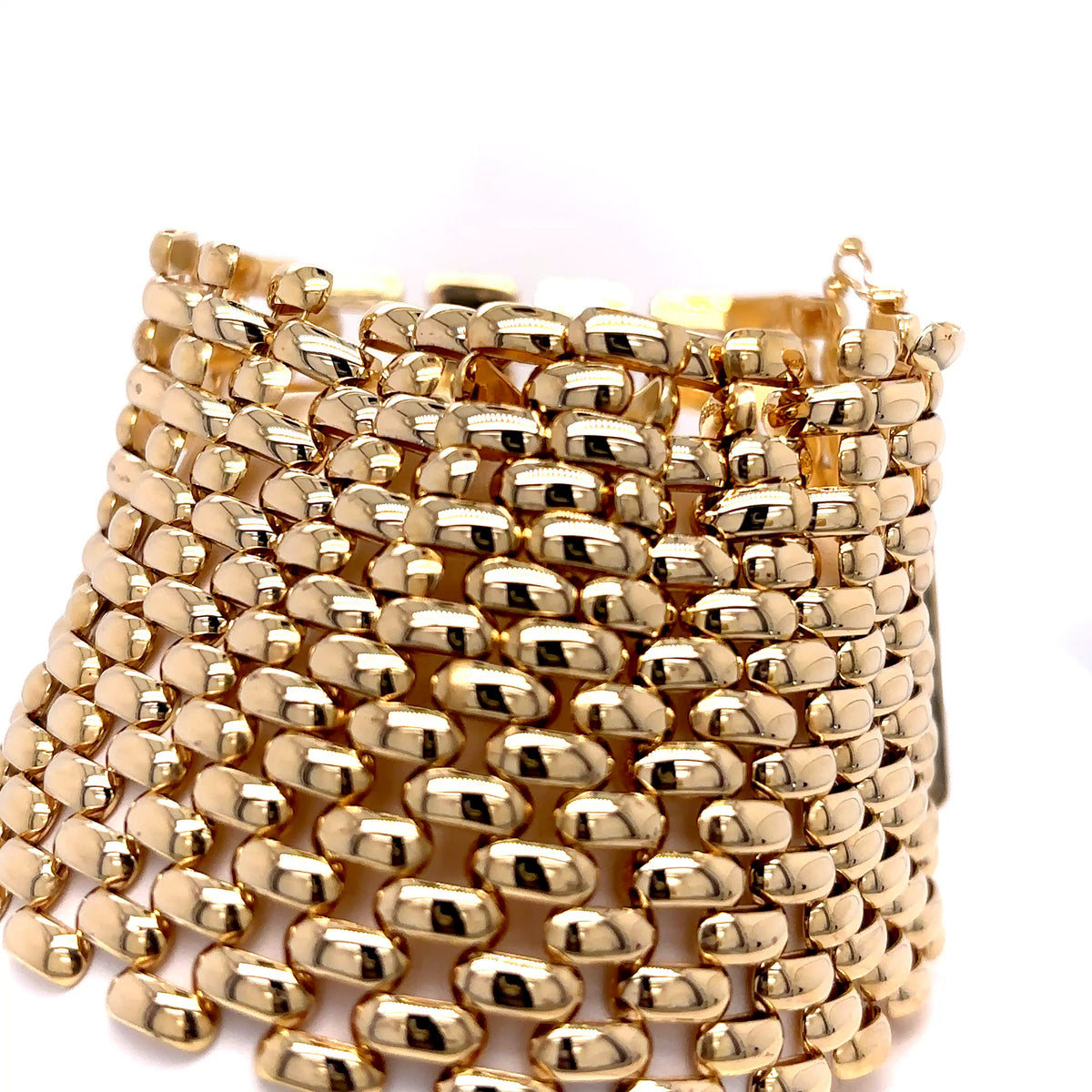 Gold beaded bracelet on a white background