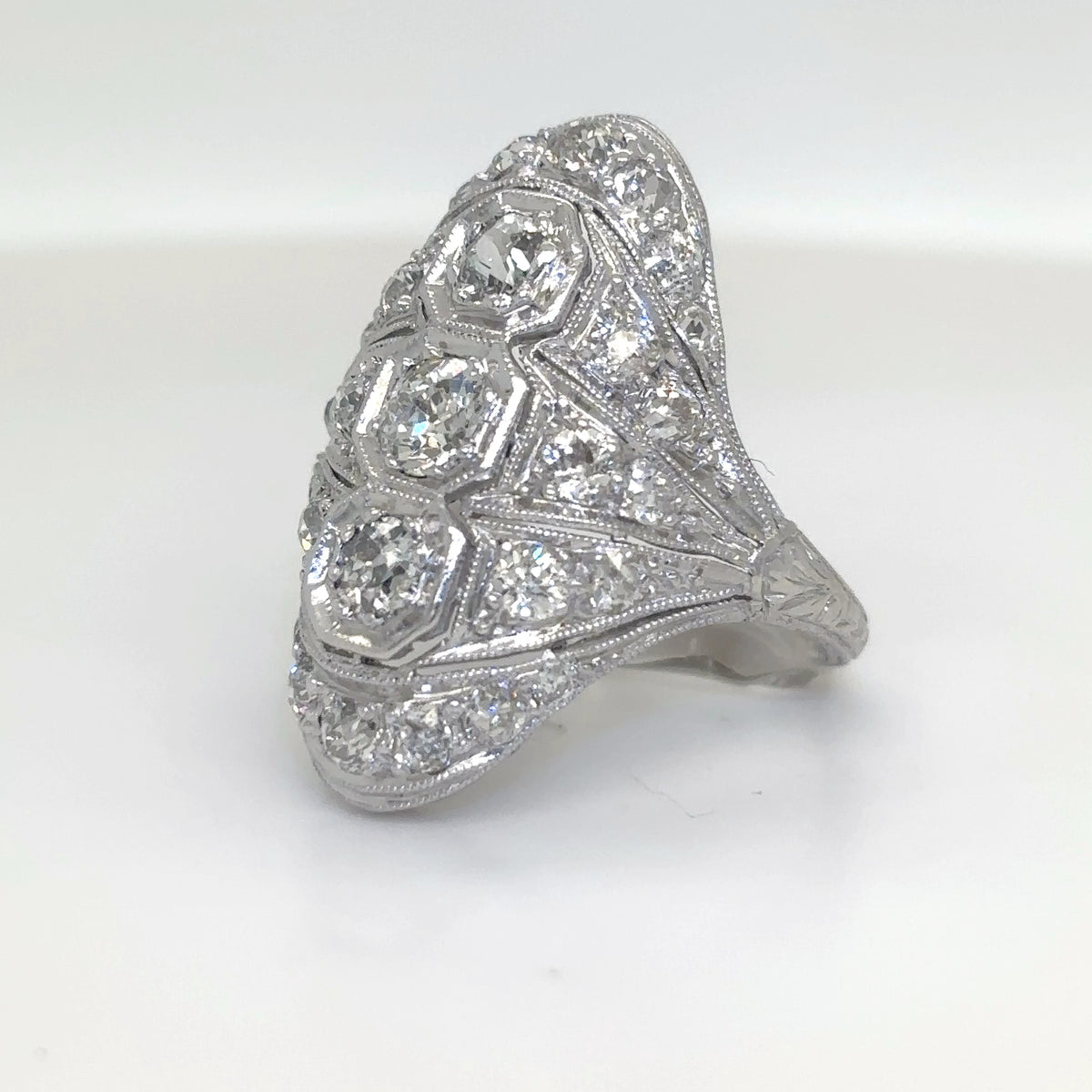 Diamond ring with intricate design on a white background